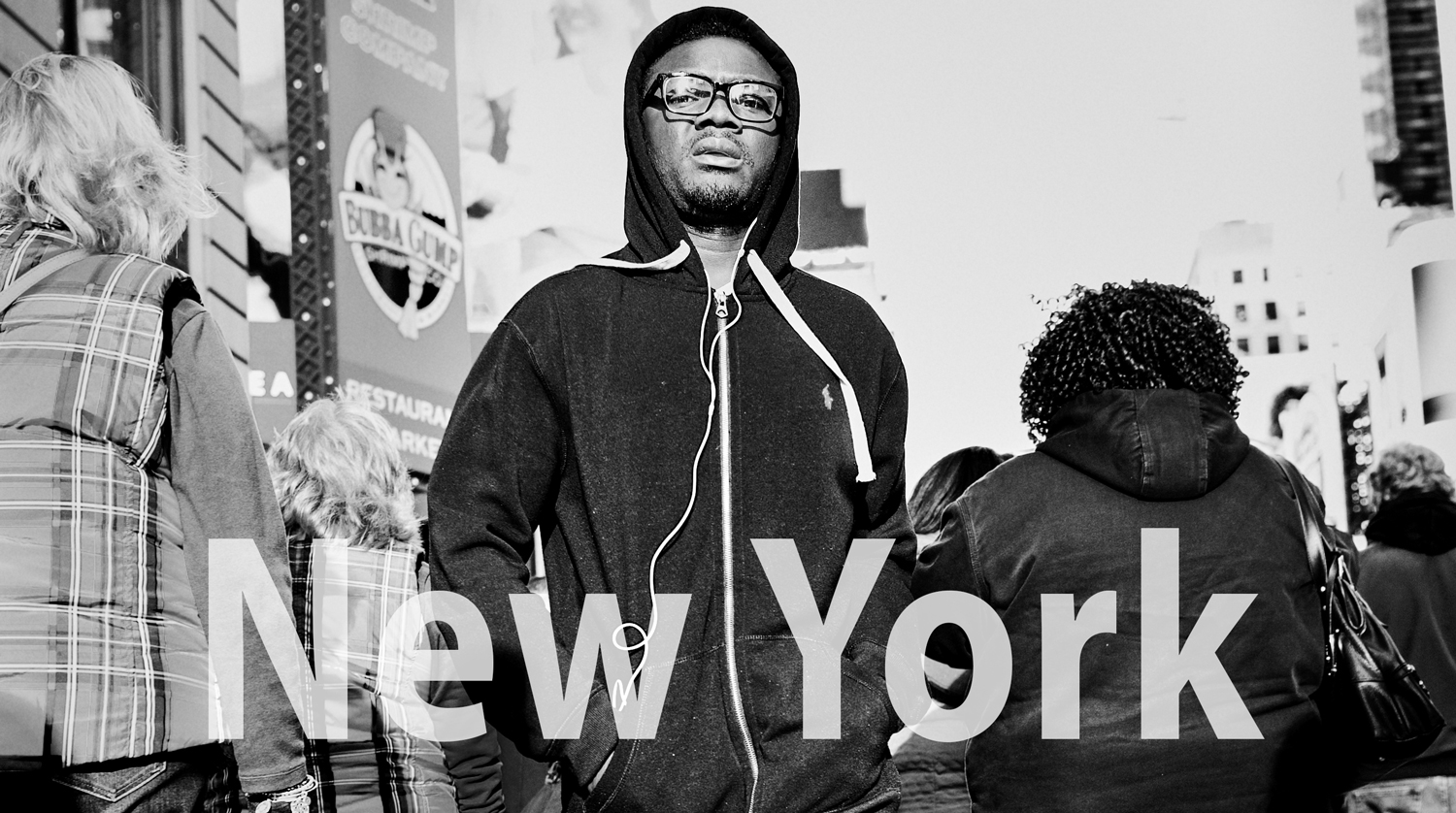 man walking through crowd city street new york candid street portrait